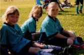 Emily in her uniform with a couple of soccer teammates